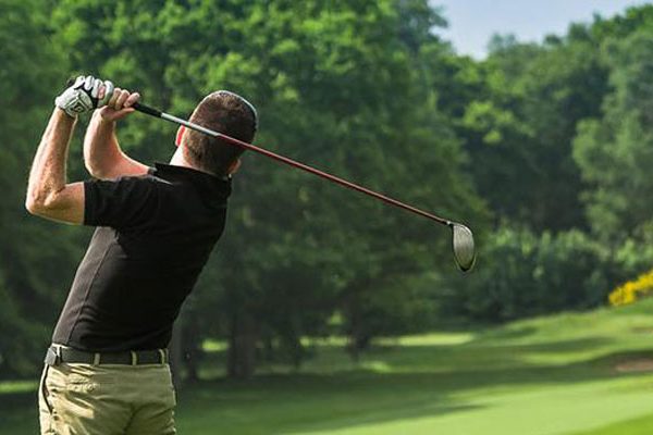 Golf swing - man in black top